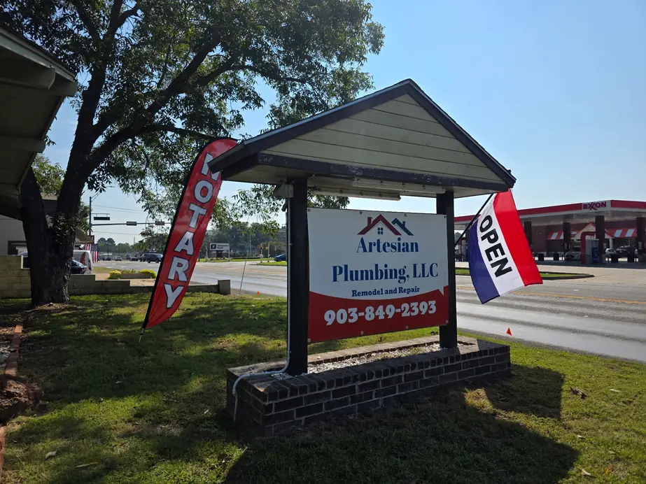 The Artesian Plumbing roadside sign on W 2nd St in Chandler, Texas